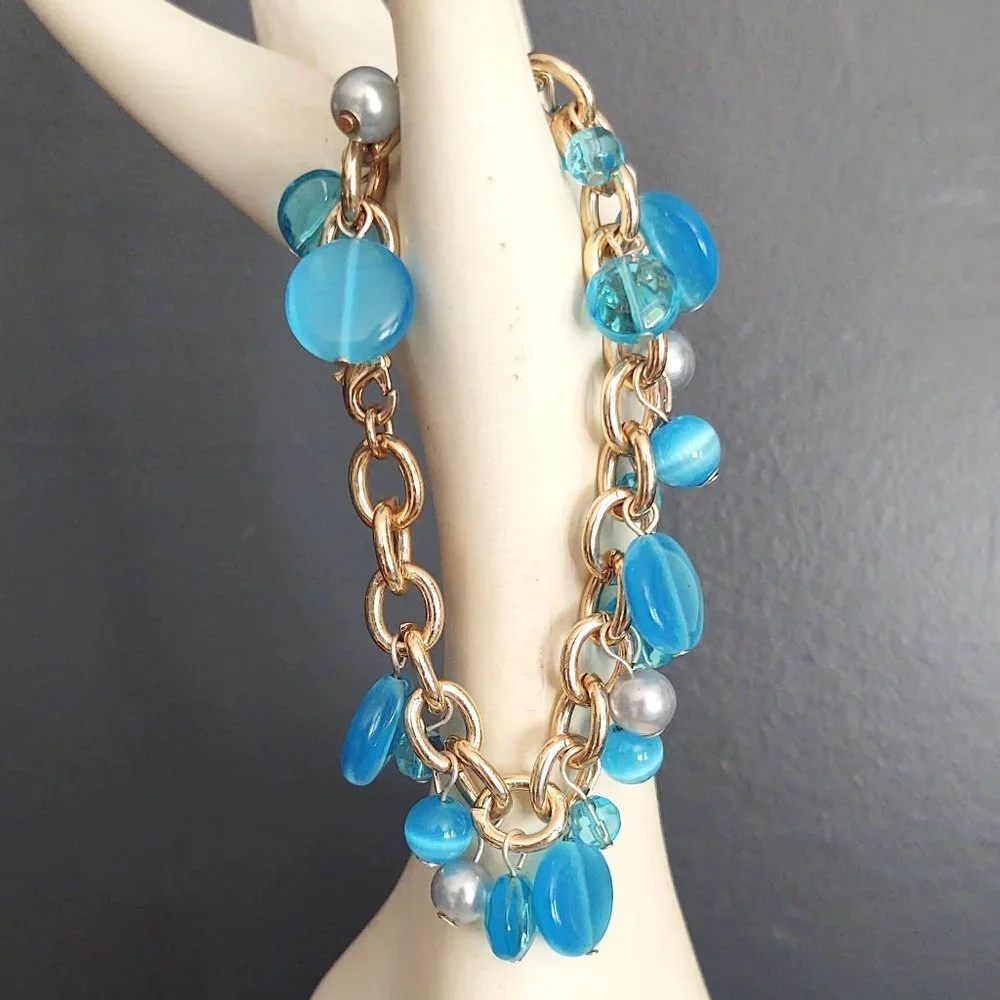 Blue bead and faux pearl charm style bracelet